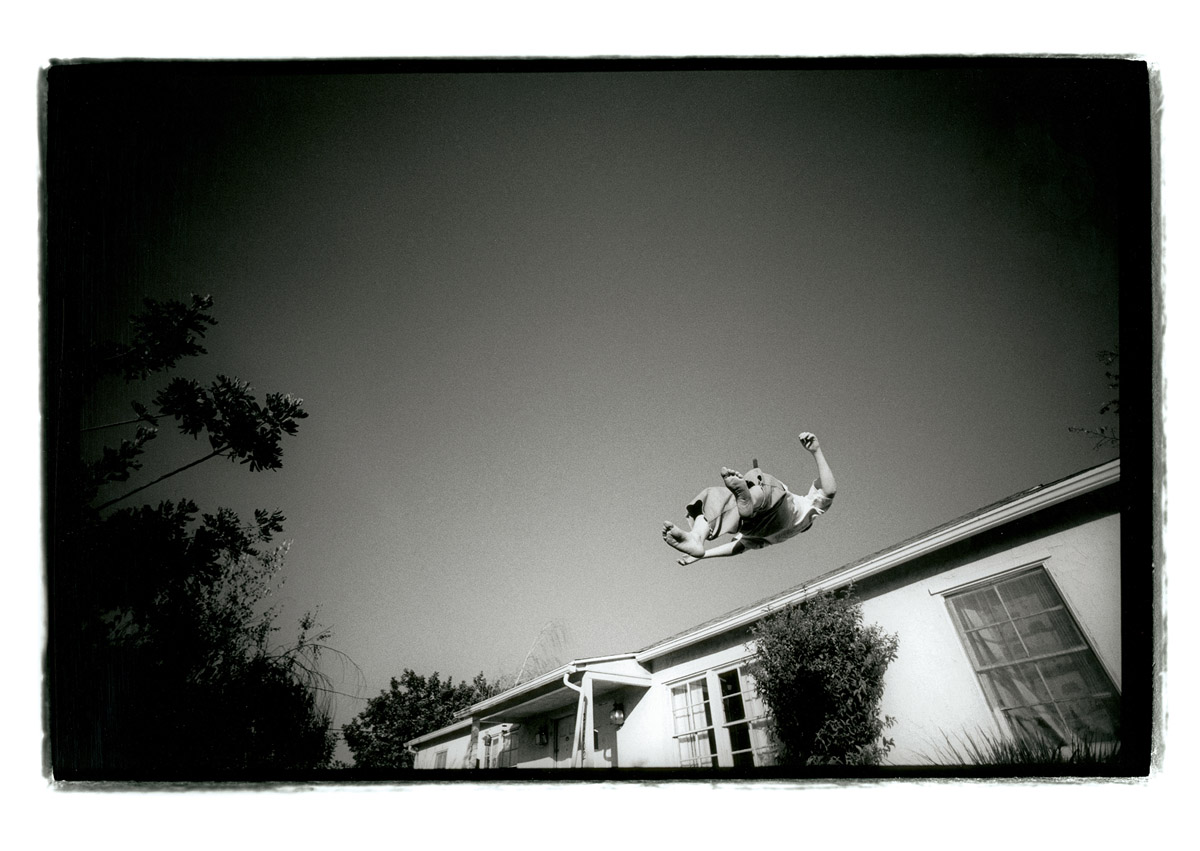 Anthony X floats above his house in the late afternoon