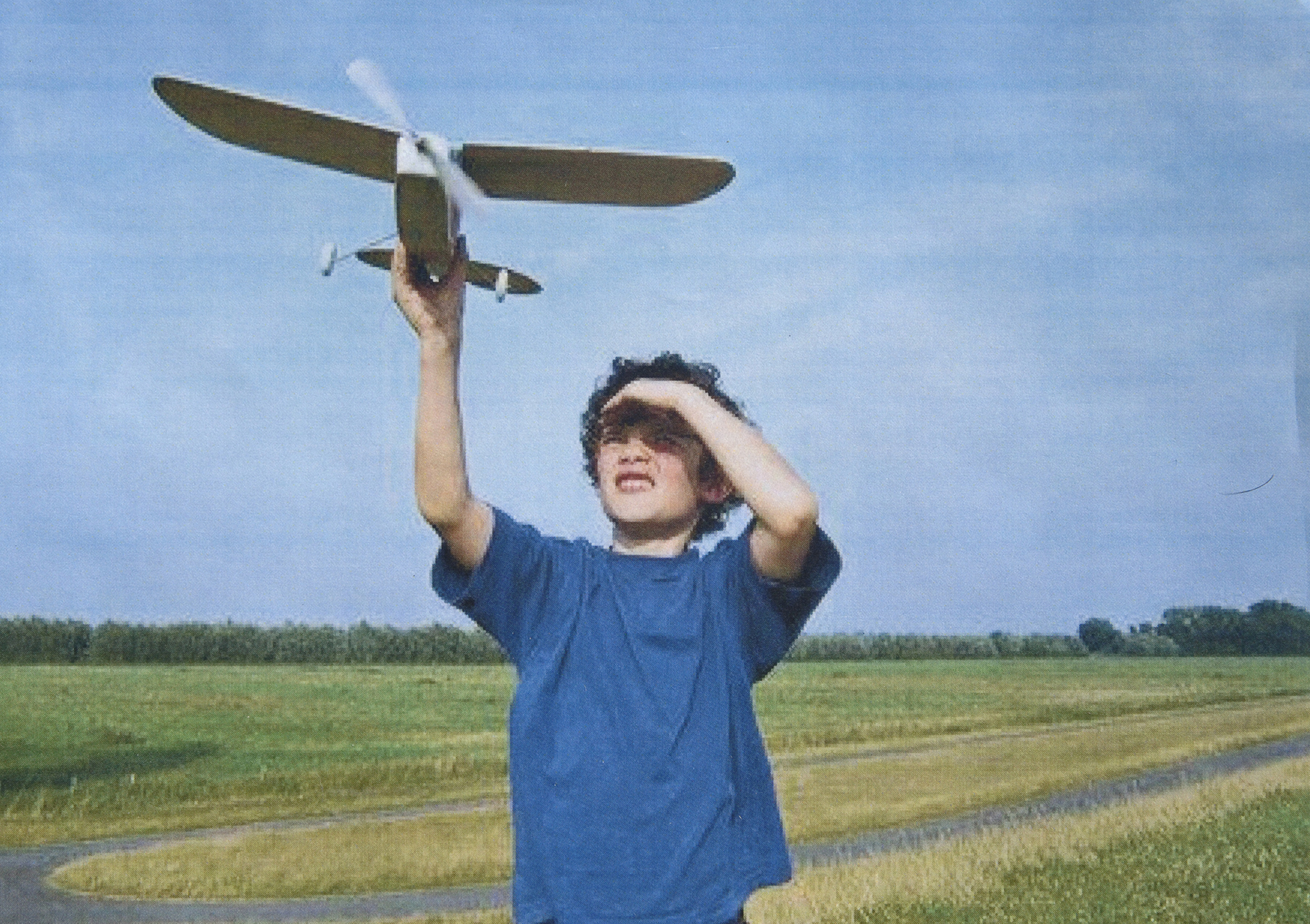 boy throwing model plane